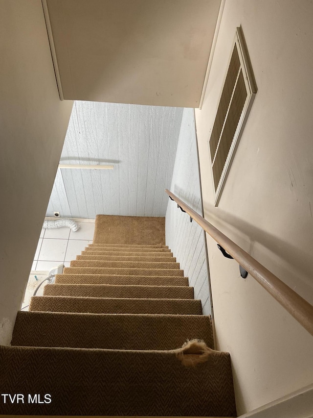 stairway with tile patterned floors and visible vents