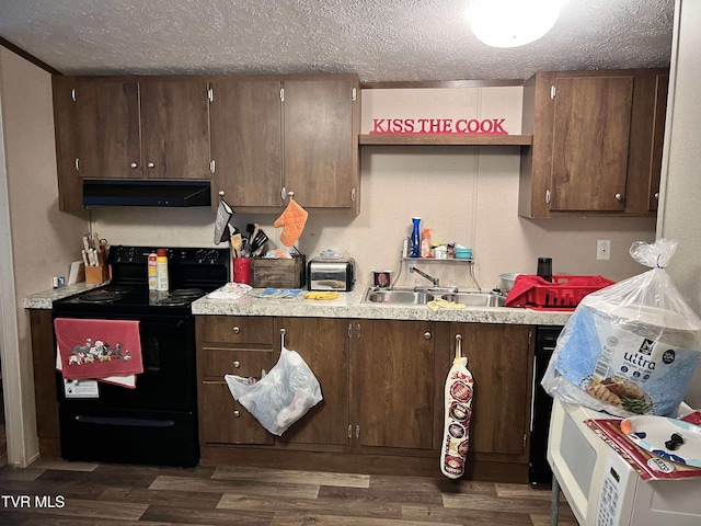 kitchen featuring under cabinet range hood, dark wood-style floors, light countertops, and black range with electric stovetop