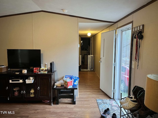 living area with lofted ceiling and light wood-style flooring