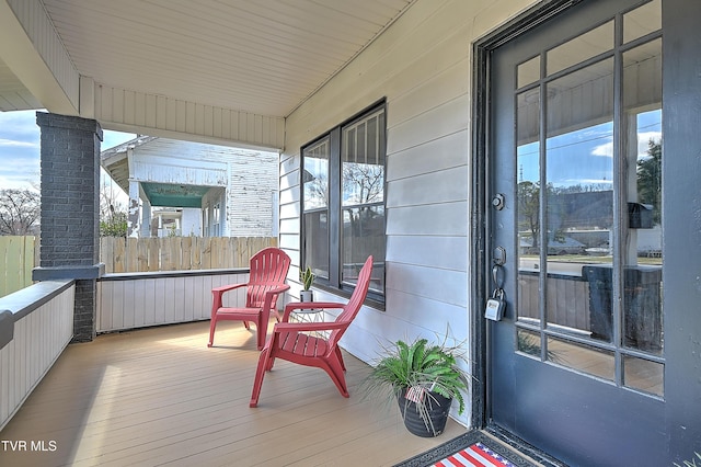 exterior space with covered porch and fence