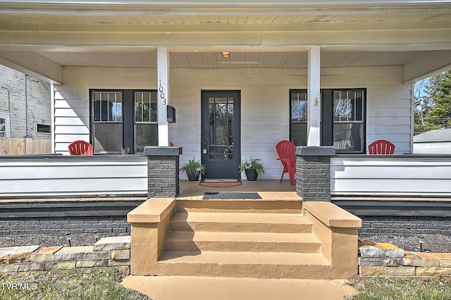 view of exterior entry with covered porch