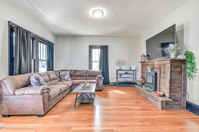 living room with light wood-style floors and a textured ceiling