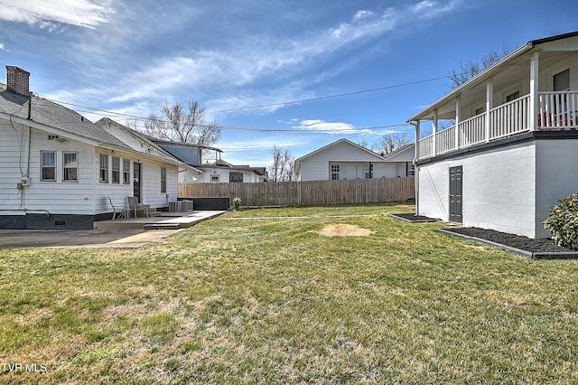 view of yard featuring a patio area, fence, and cooling unit