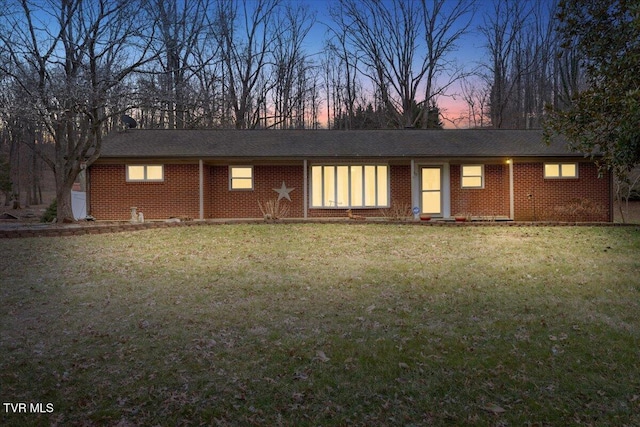 view of front of house with a front lawn and brick siding