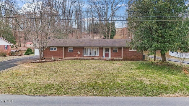 ranch-style home with driveway, a front lawn, and brick siding