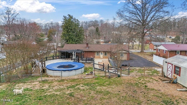 back of house with a wooden deck, a gate, and fence