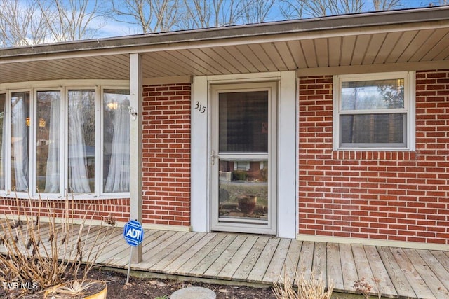 property entrance with brick siding