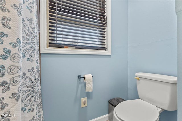 bathroom featuring baseboards and toilet