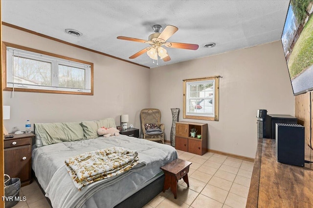 bedroom with ornamental molding, visible vents, baseboards, and light tile patterned floors