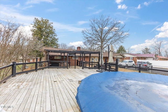 deck featuring a residential view and fence