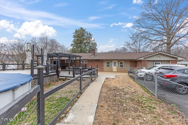 ranch-style home with brick siding, a chimney, fence, and a pergola