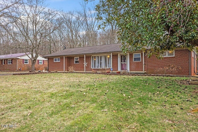 ranch-style house featuring brick siding and a front lawn