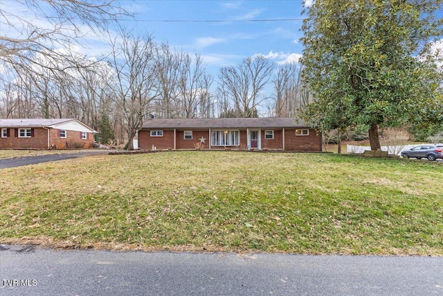 ranch-style home with a front lawn and brick siding