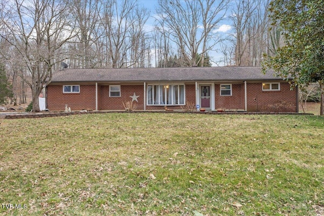 ranch-style house with a front lawn and brick siding