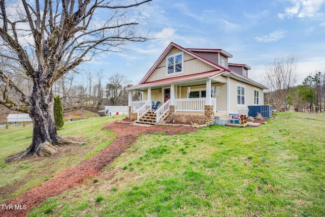 view of front of home with a porch, cooling unit, metal roof, and a front lawn