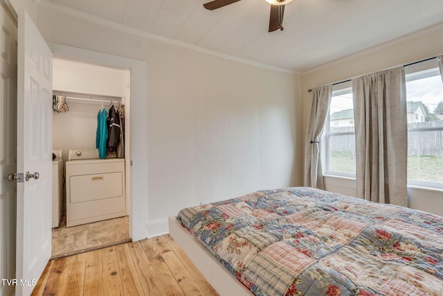 bedroom featuring light wood-style flooring, ornamental molding, and ceiling fan