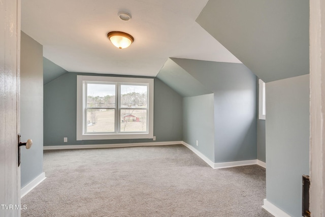 additional living space with carpet, vaulted ceiling, and baseboards