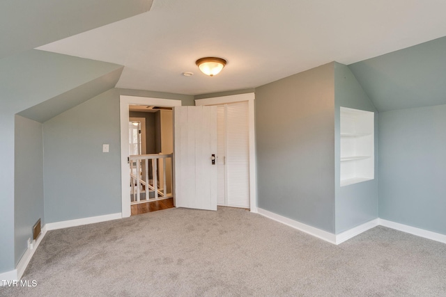 bonus room with vaulted ceiling, carpet, visible vents, and baseboards