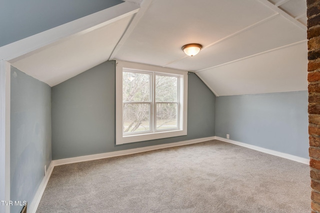 bonus room with lofted ceiling, carpet floors, and baseboards