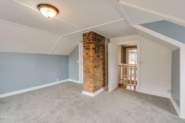 bonus room with vaulted ceiling, carpet, and baseboards