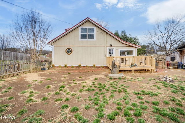 rear view of property with a fenced backyard and a wooden deck