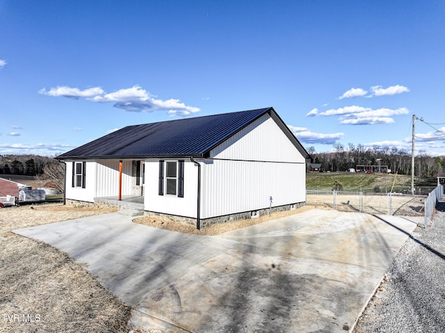 exterior space with metal roof and fence