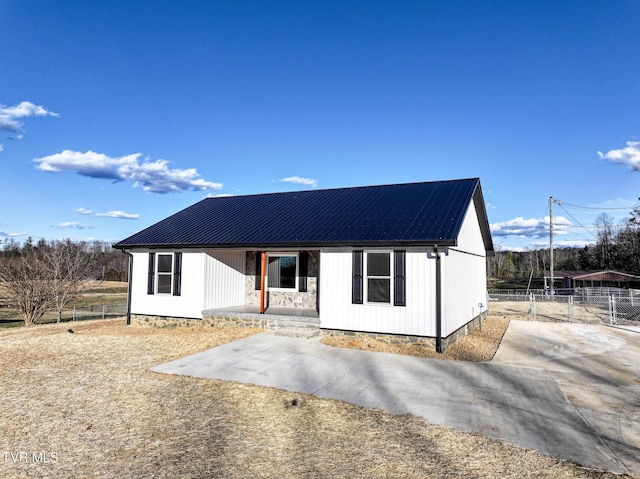 view of front of house with fence and metal roof