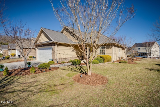 view of front facade featuring a garage, driveway, a front lawn, and brick siding