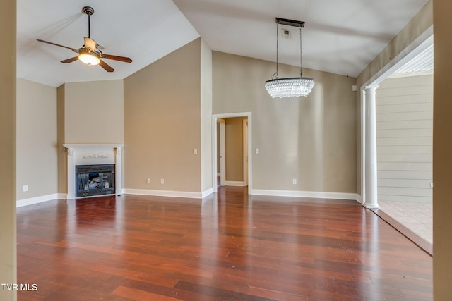 unfurnished living room with baseboards, a glass covered fireplace, ceiling fan, wood finished floors, and high vaulted ceiling