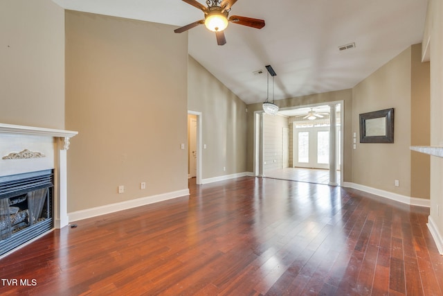 unfurnished living room with a fireplace, wood finished floors, a ceiling fan, visible vents, and baseboards