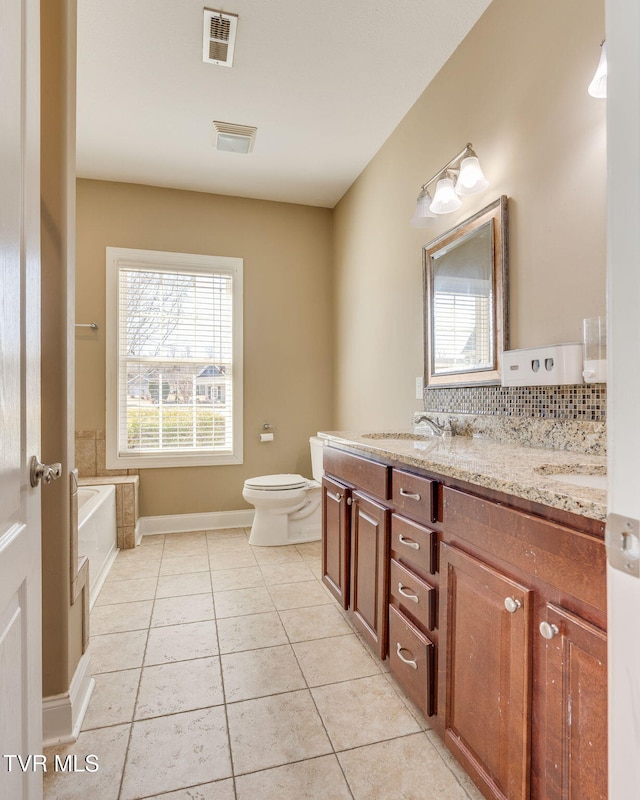 bathroom featuring double vanity, visible vents, toilet, tile patterned floors, and a sink