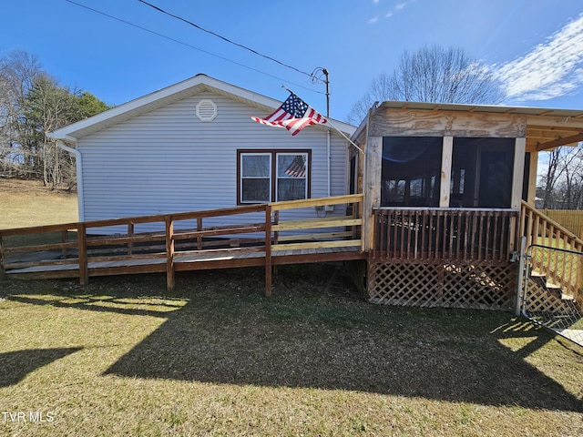 back of property featuring a yard and a wooden deck