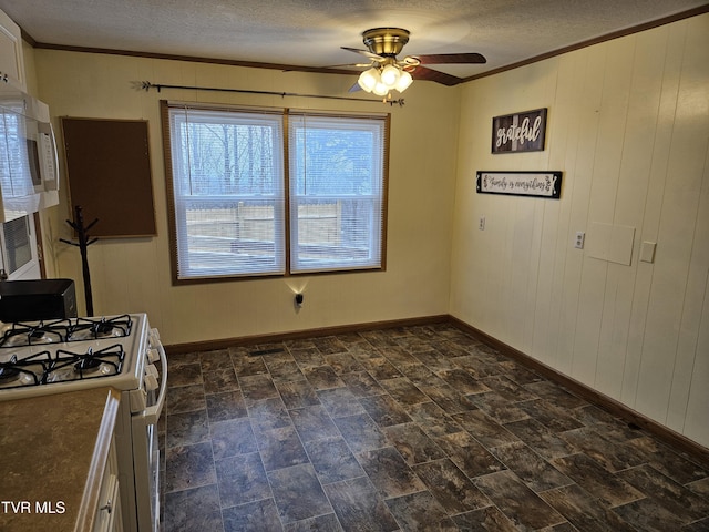 kitchen with white appliances, baseboards, ceiling fan, ornamental molding, and a textured ceiling