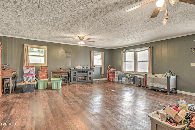 game room featuring hardwood / wood-style flooring, plenty of natural light, and ornamental molding