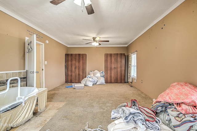 carpeted bedroom with ceiling fan and ornamental molding