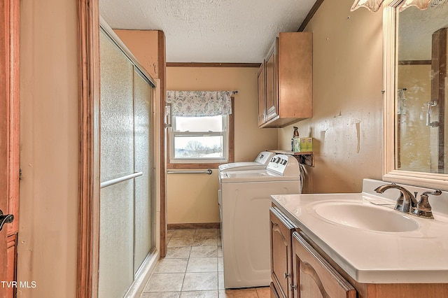 interior space featuring a textured ceiling, independent washer and dryer, tile patterned flooring, and a shower stall