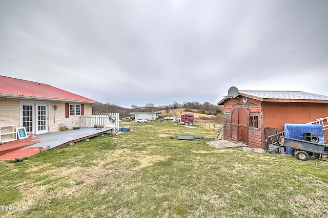 view of yard with a storage shed, an outdoor structure, and a wooden deck