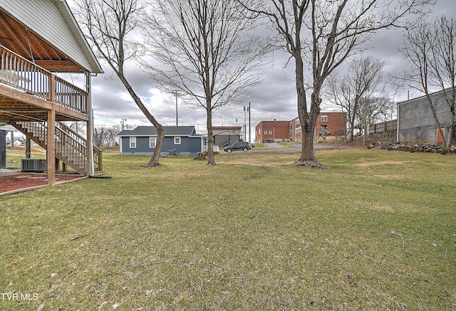 view of yard with a deck and stairway