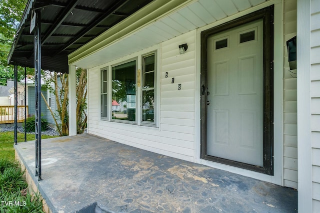 view of exterior entry featuring a porch