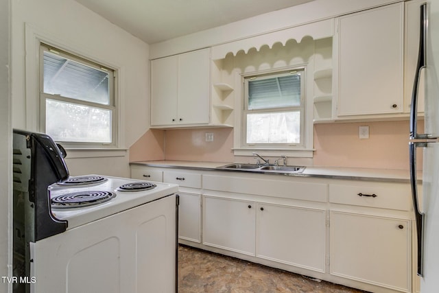 kitchen featuring open shelves, freestanding refrigerator, a sink, white cabinets, and white range with electric stovetop