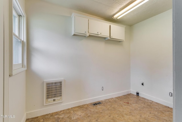 clothes washing area with heating unit, baseboards, visible vents, hookup for an electric dryer, and laundry area