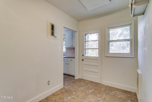 doorway to outside with baseboards