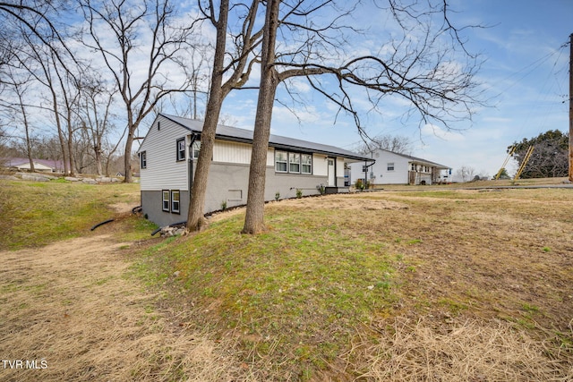 view of side of home featuring a lawn