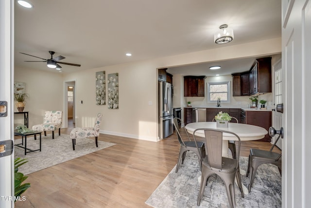 dining room featuring recessed lighting, ceiling fan, baseboards, and light wood-style floors