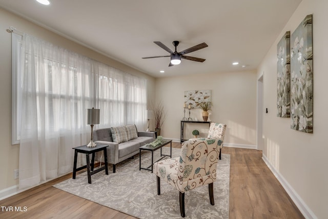 living area with recessed lighting, baseboards, a ceiling fan, and wood finished floors