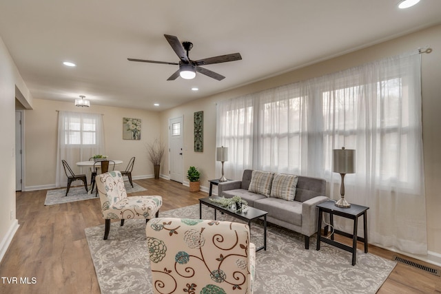 living room with visible vents, baseboards, ceiling fan, recessed lighting, and wood finished floors