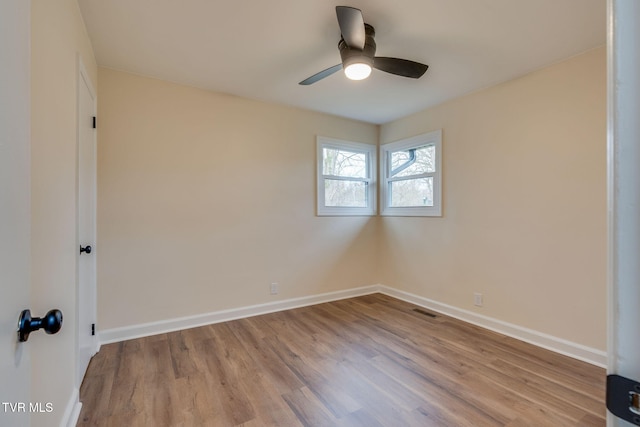 unfurnished bedroom with visible vents, a ceiling fan, baseboards, and wood finished floors