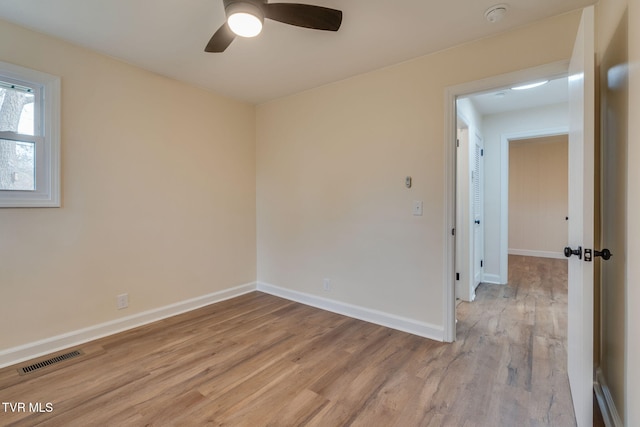 spare room with visible vents, baseboards, ceiling fan, and light wood finished floors