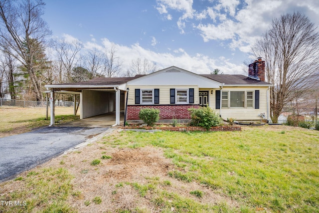 single story home with brick siding, fence, driveway, a carport, and a chimney