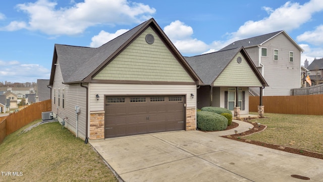 view of front facade with a garage, a front yard, concrete driveway, and fence